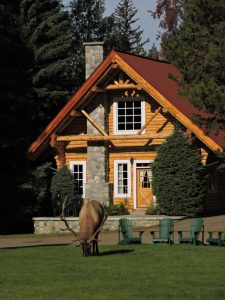 Exterior of Alpine Village Jasper with elk on front lawn