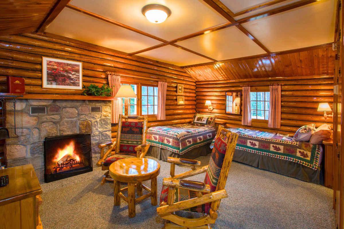 Heritage one room cabin with twin beds and fireplace - interior at alpine village