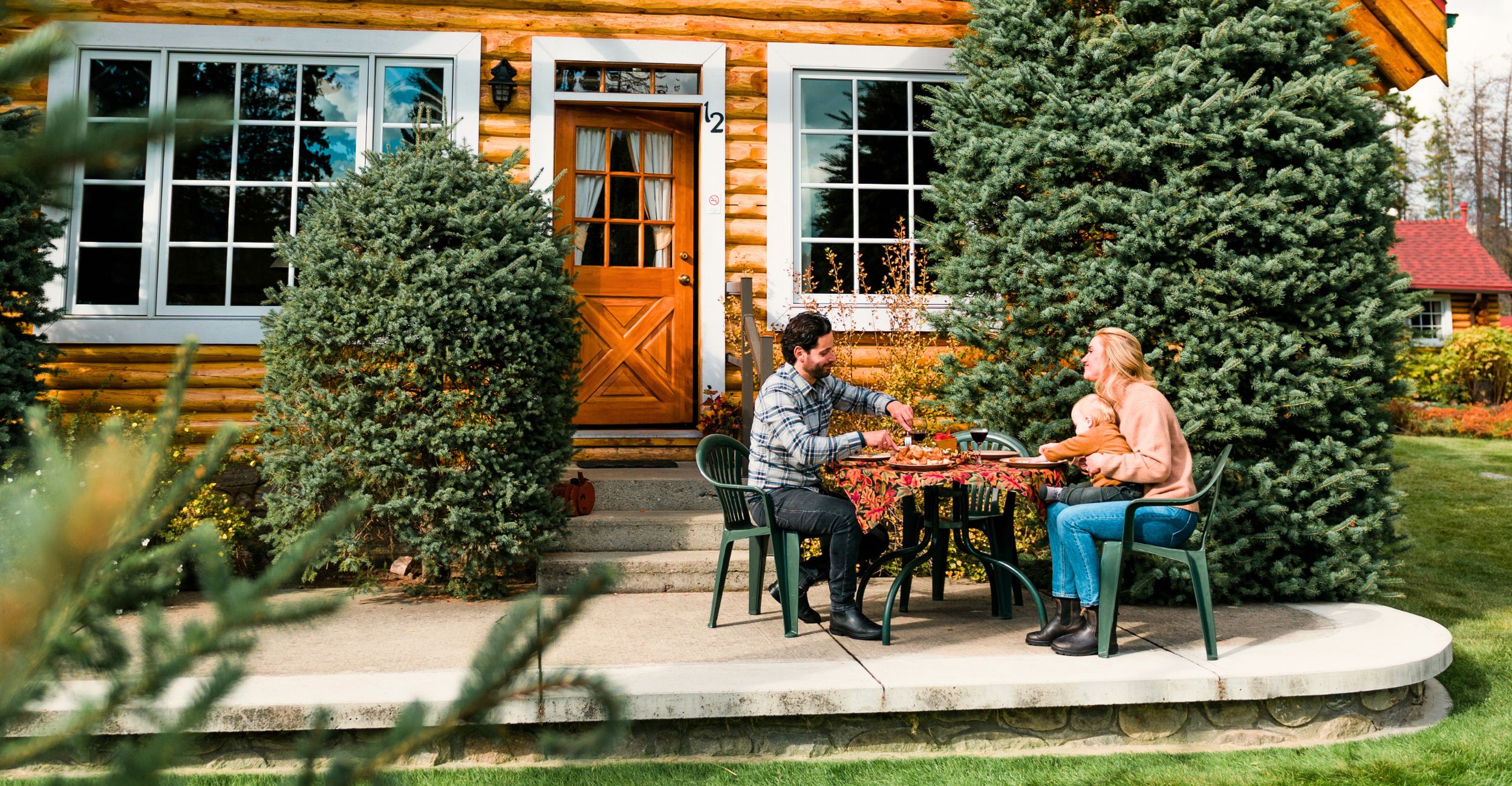 A family eating outside of their cabin at Alpine Village Jasper
