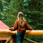 Woman looking out over her private deck at Alpine Village