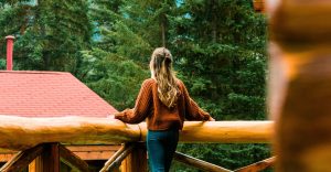 Woman looking out over her private deck at Alpine Village